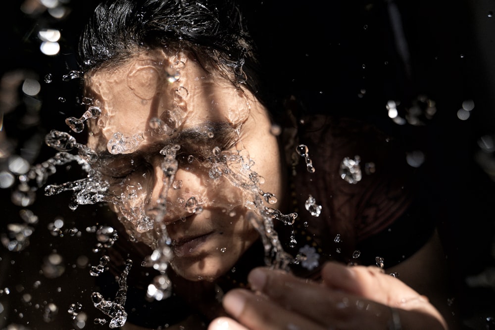 woman in black shirt with water droplets