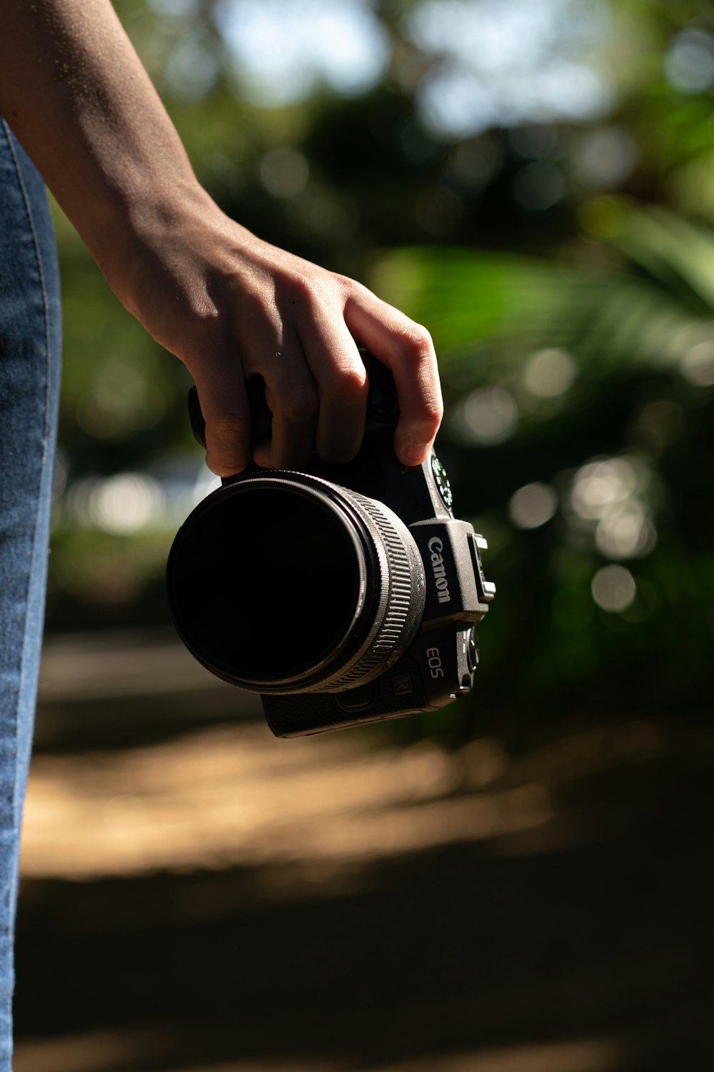 person holding black and silver camera