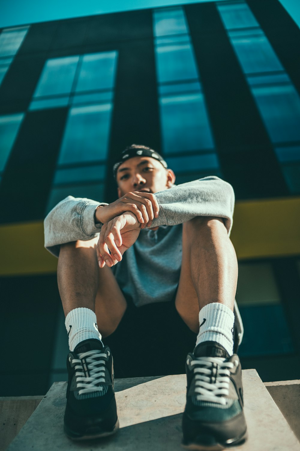 man in black and white nike shorts and white socks sitting on yellow chair