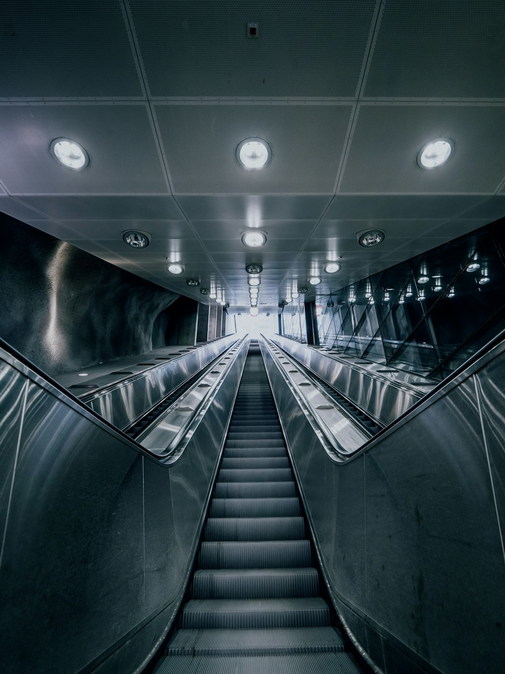 gray and black escalator in a building
