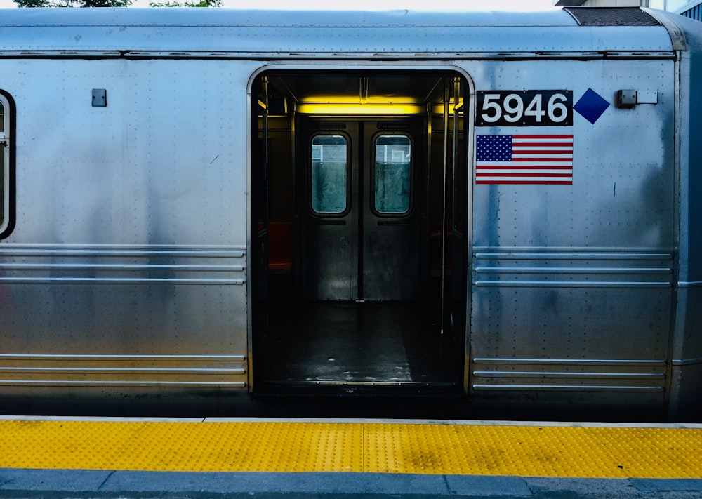 gray and blue train in train station