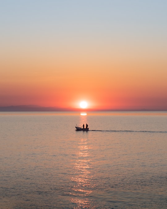 silhouette of 2 people riding on boat on sea during sunset in Ventotene Island Italy