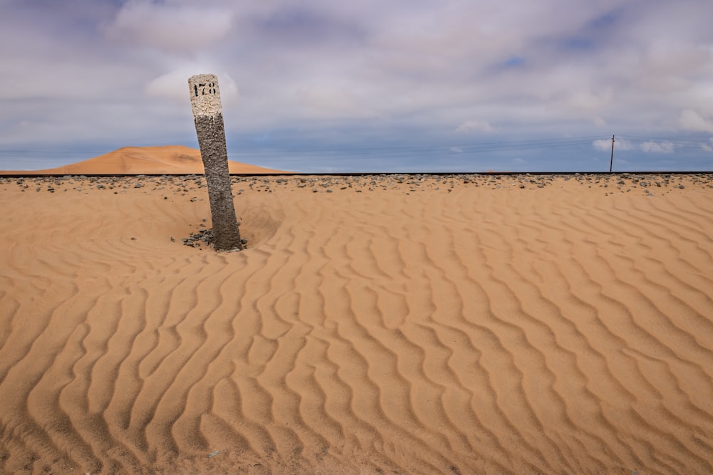 brown sand under cloudy sky during daytime