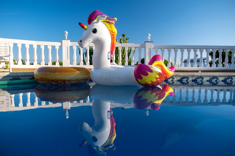 white and yellow duck on water fountain