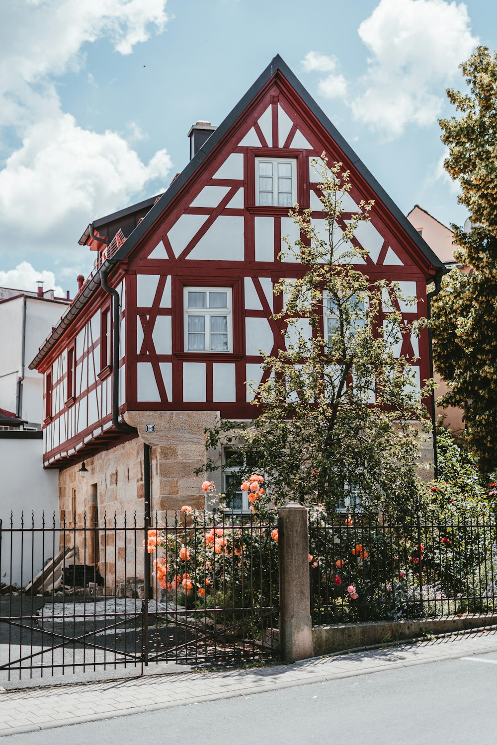 red and white concrete building near green trees during daytime