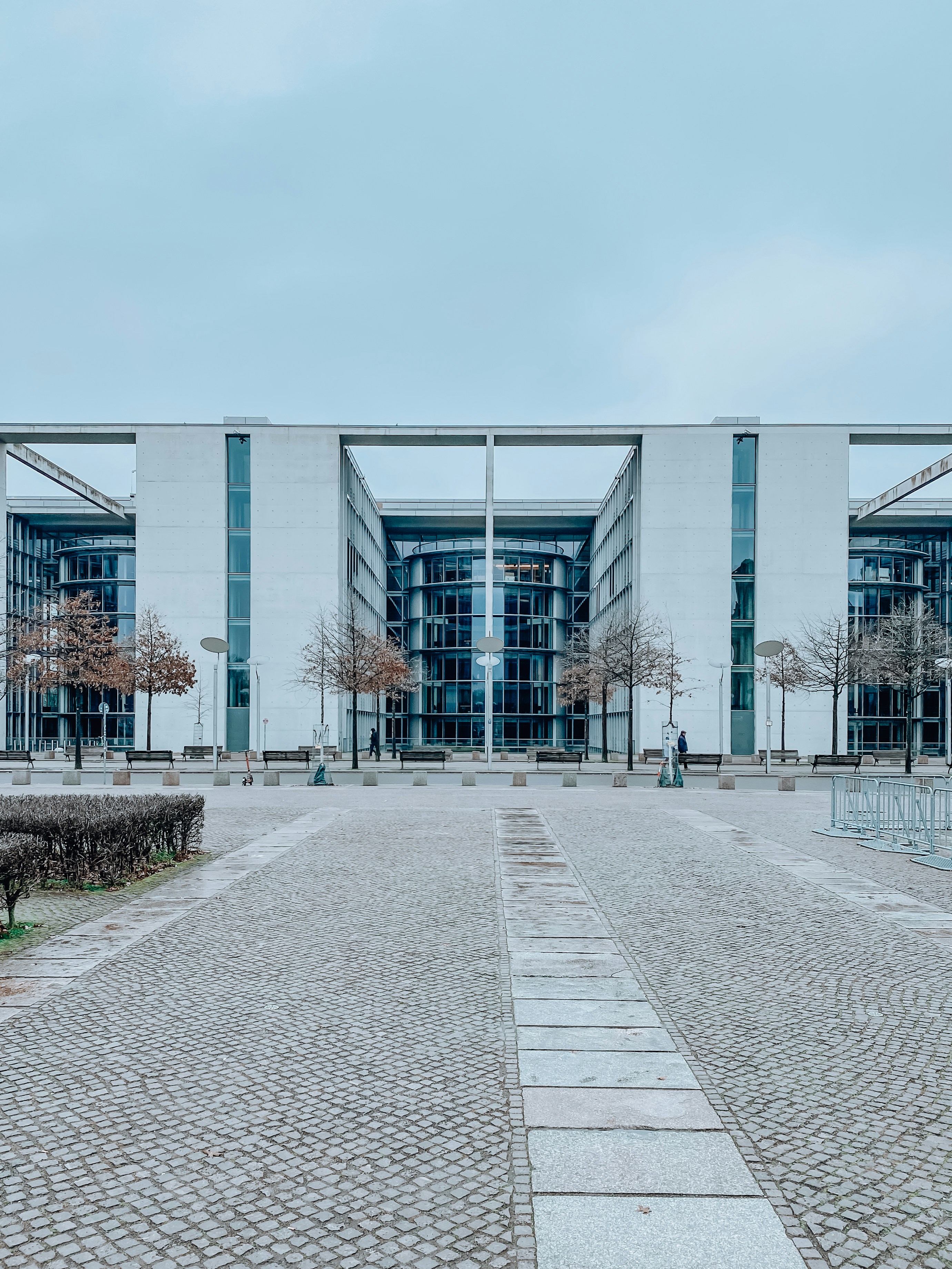 gray concrete road near glass building during daytime