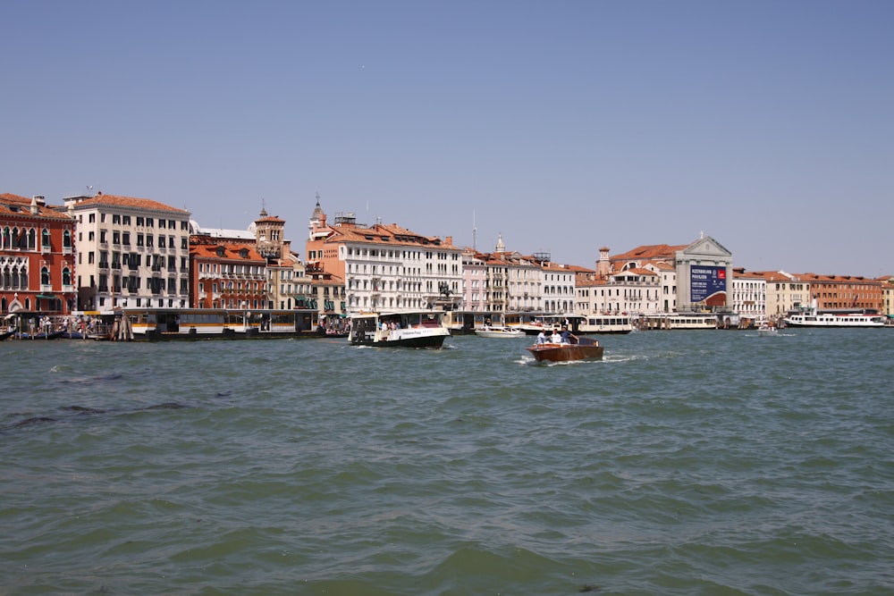 white and brown concrete building beside body of water during daytime