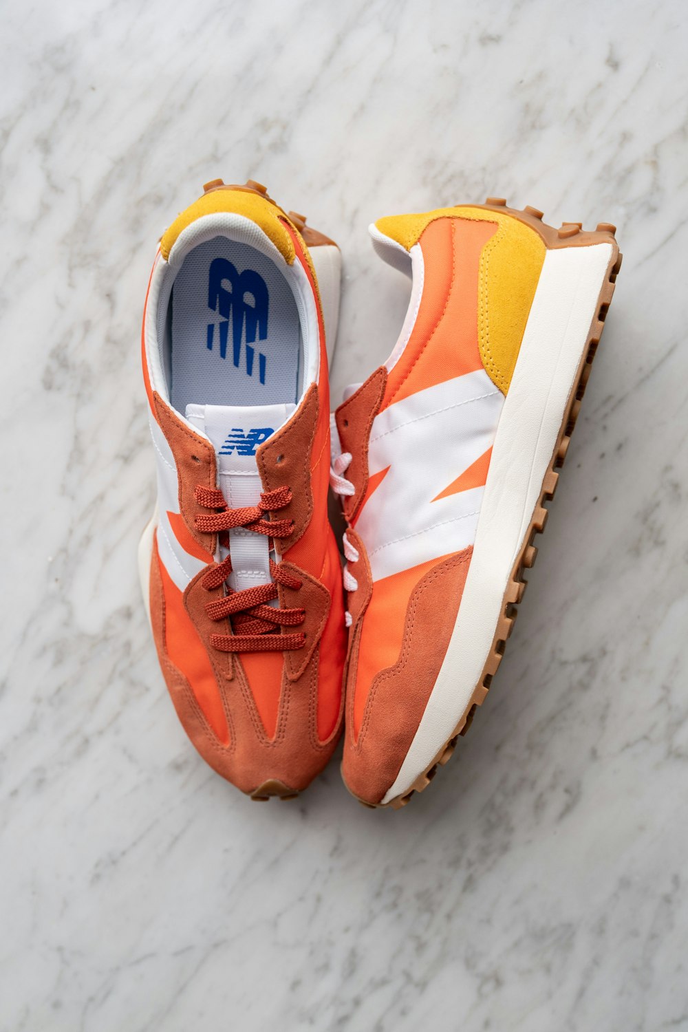orange and white nike athletic shoes