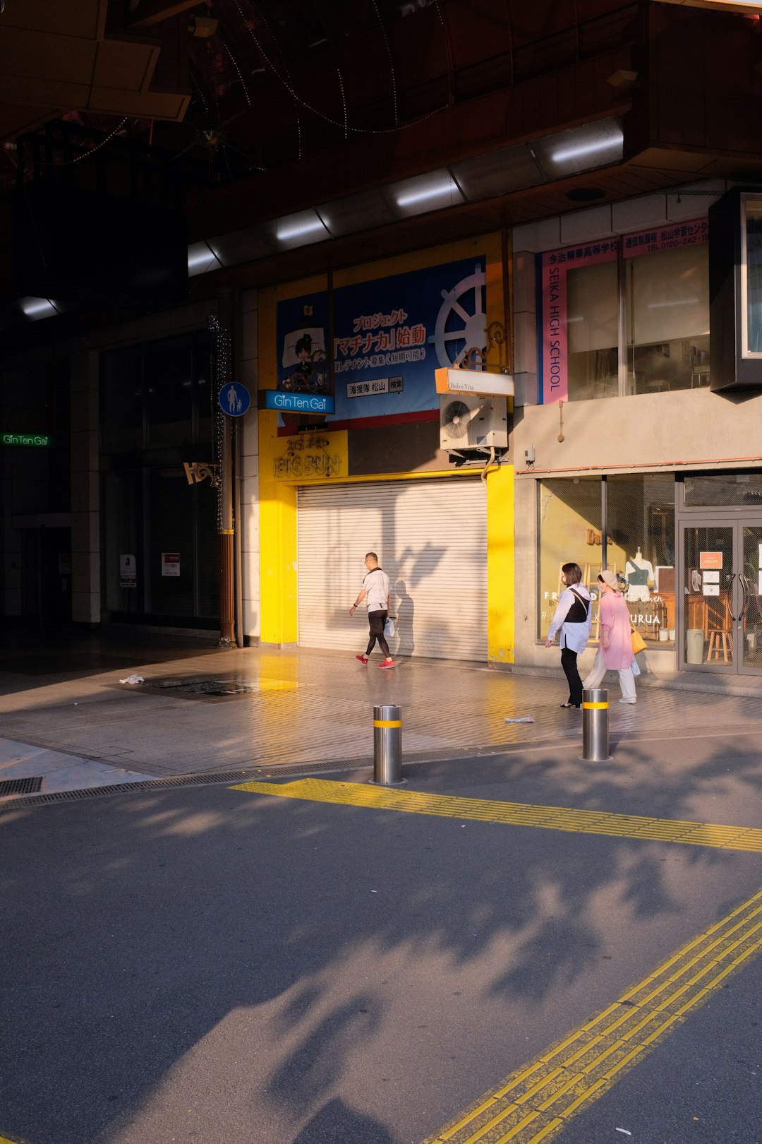 man and woman walking on sidewalk during daytime