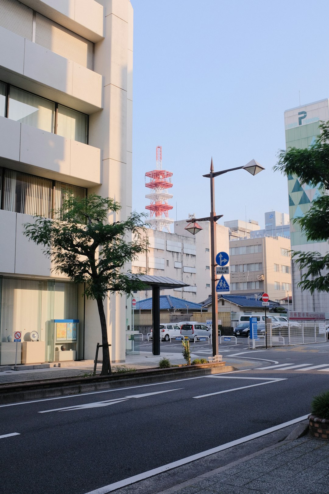 white and brown concrete building near green trees during daytime