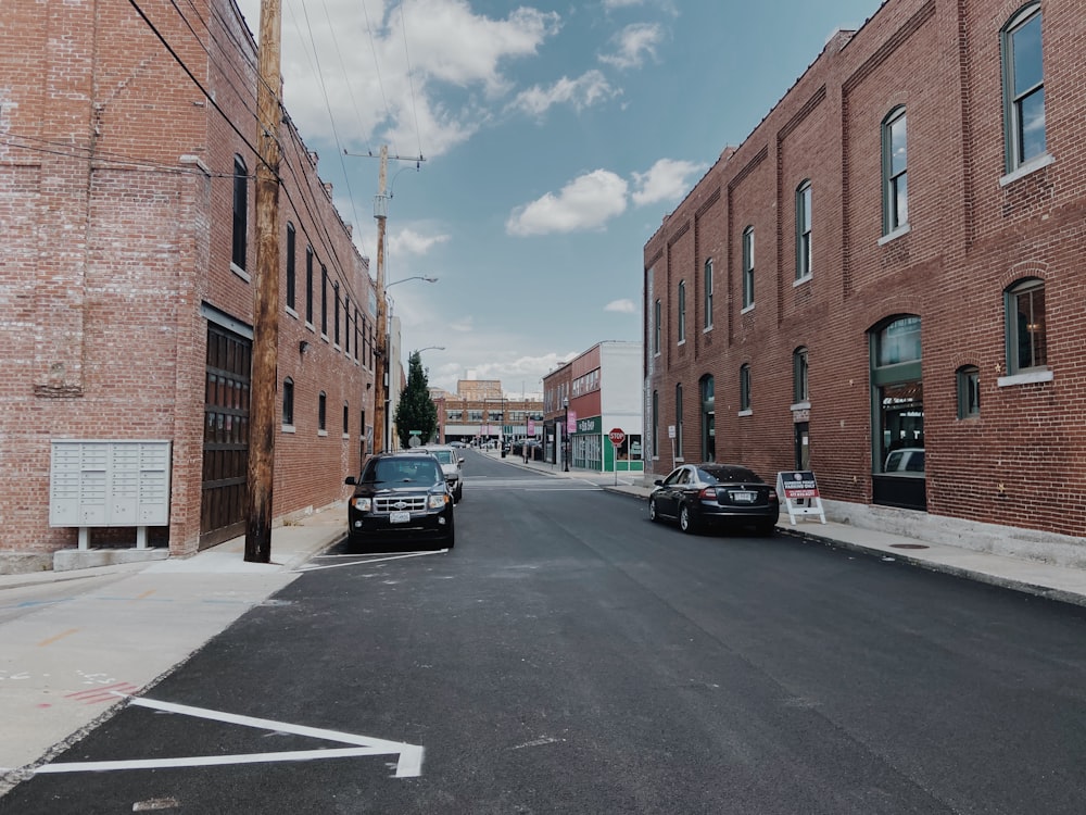 cars parked in front of brown building during daytime