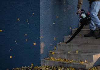 man in black jacket and pants standing on stairs