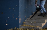 man in black jacket and pants standing on stairs