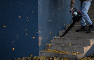 man in black jacket and pants standing on stairs