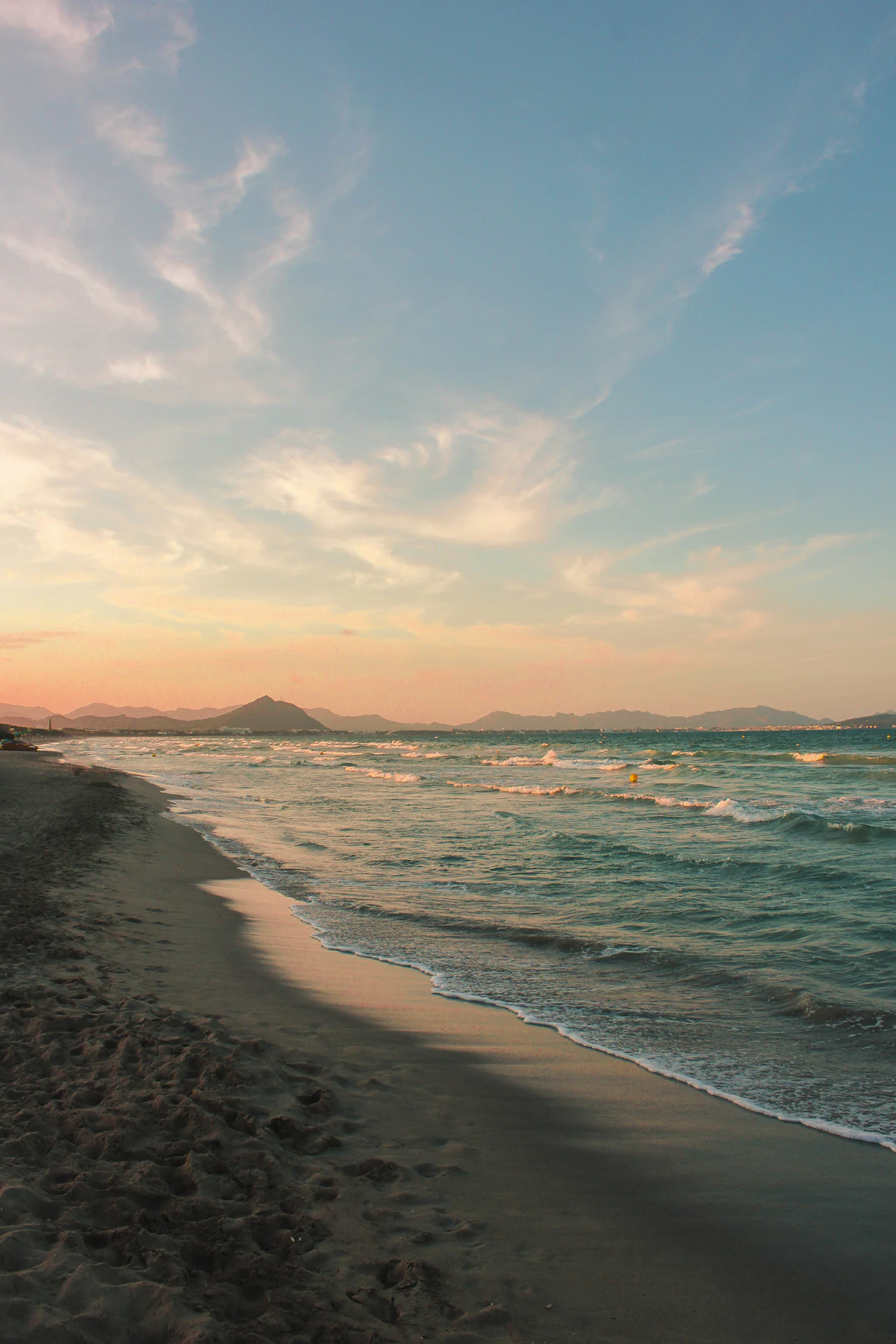 Sea waves crashing on shore during sunset