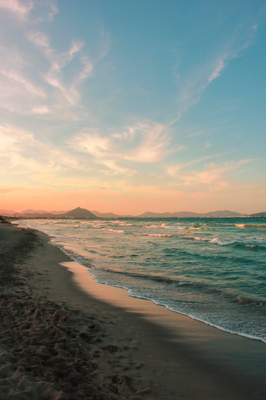 sea waves crashing on shore during sunset in Majorca Spain