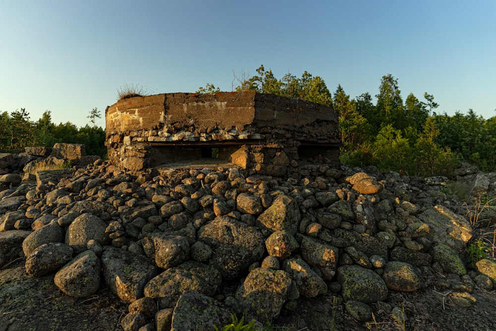 brown concrete building on rocky hill under blue sky during daytime