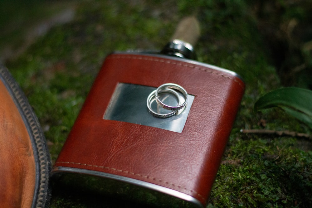 silver ring on brown leather wallet