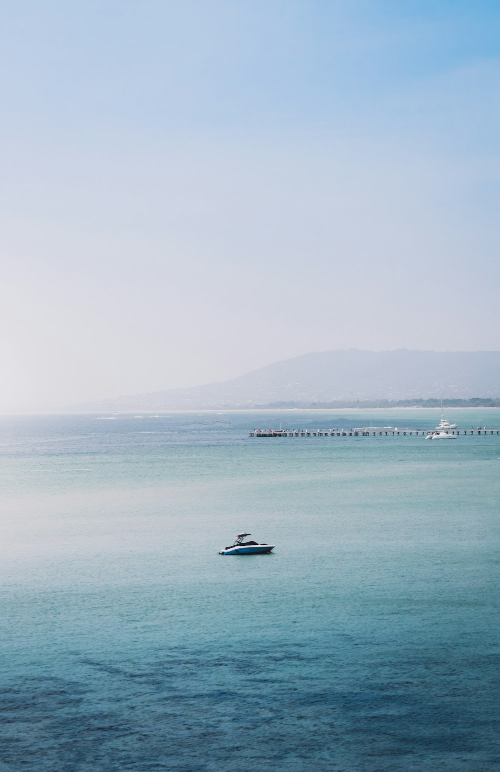 white and black boat on sea during daytime