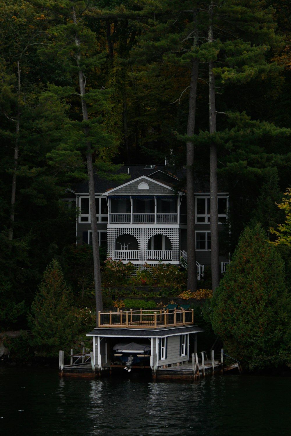 white wooden house surrounded by green trees during daytime