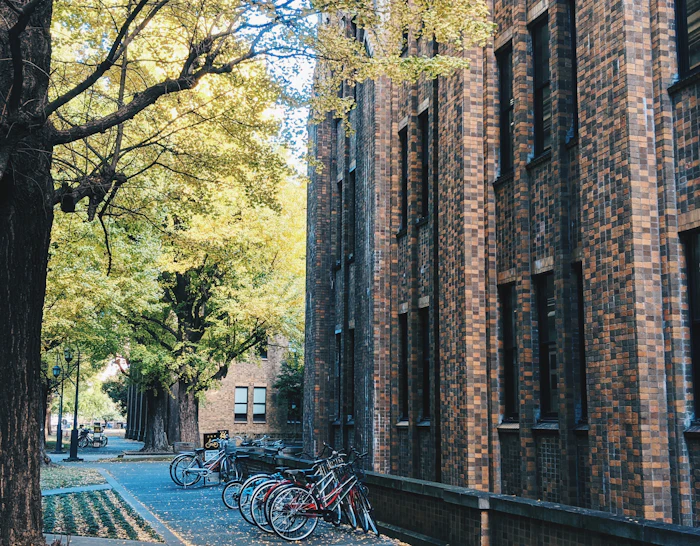 Bicycle parked beside a university campus building