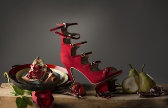 red and black guitar on white surface