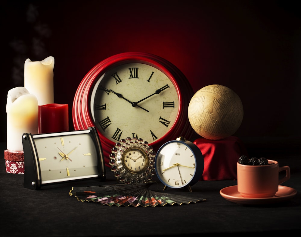 red and white alarm clock beside brown round fruit
