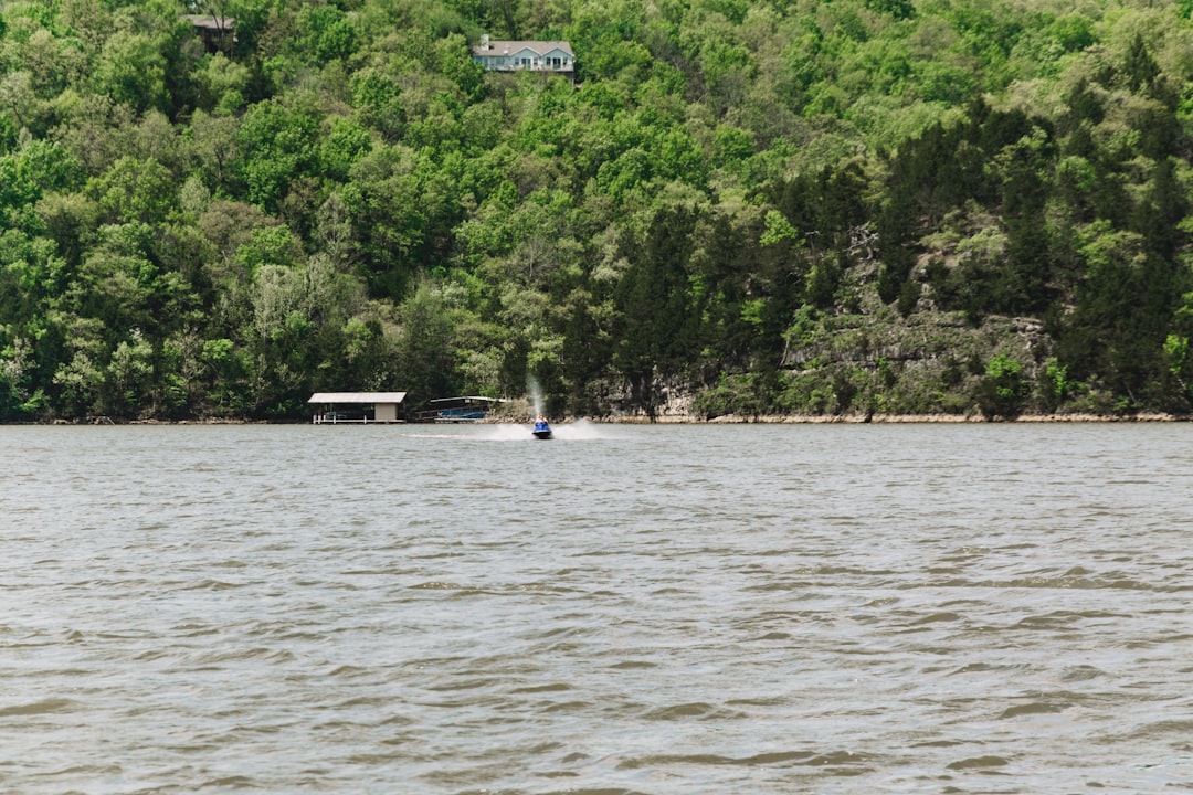 people riding on boat on river during daytime