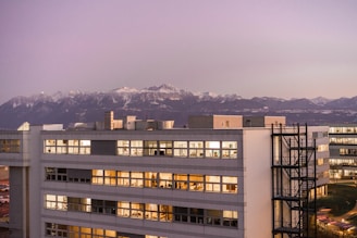 white and brown concrete building near mountain during daytime