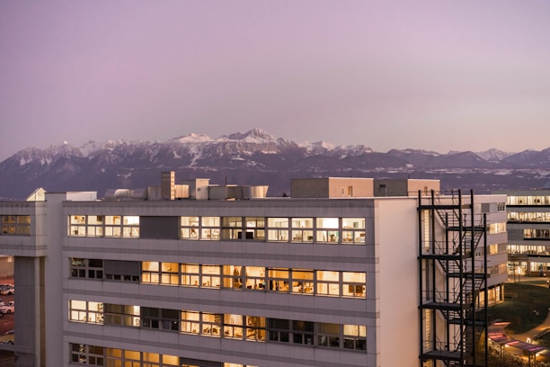 white and brown concrete building near mountain during daytime