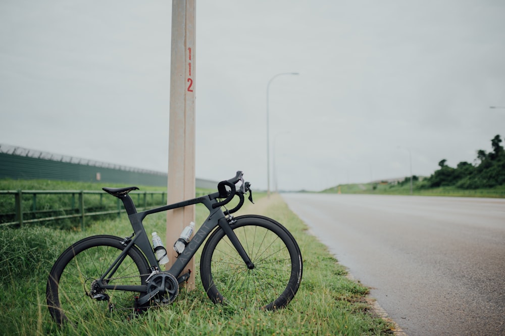 black and gray bicycle on gray asphalt road during daytime