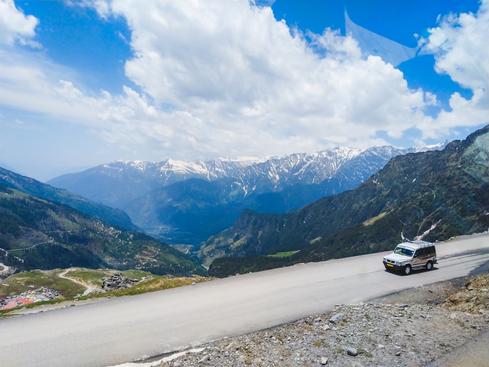 white car on road near mountains during daytime