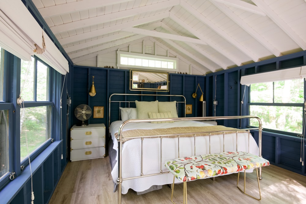 white bed near white wooden cabinet