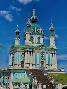 green and brown concrete building under blue sky during daytime