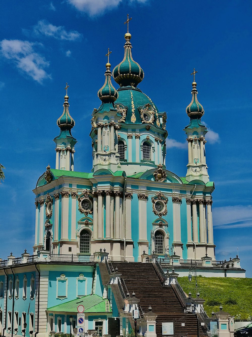 green and brown concrete building under blue sky during daytime