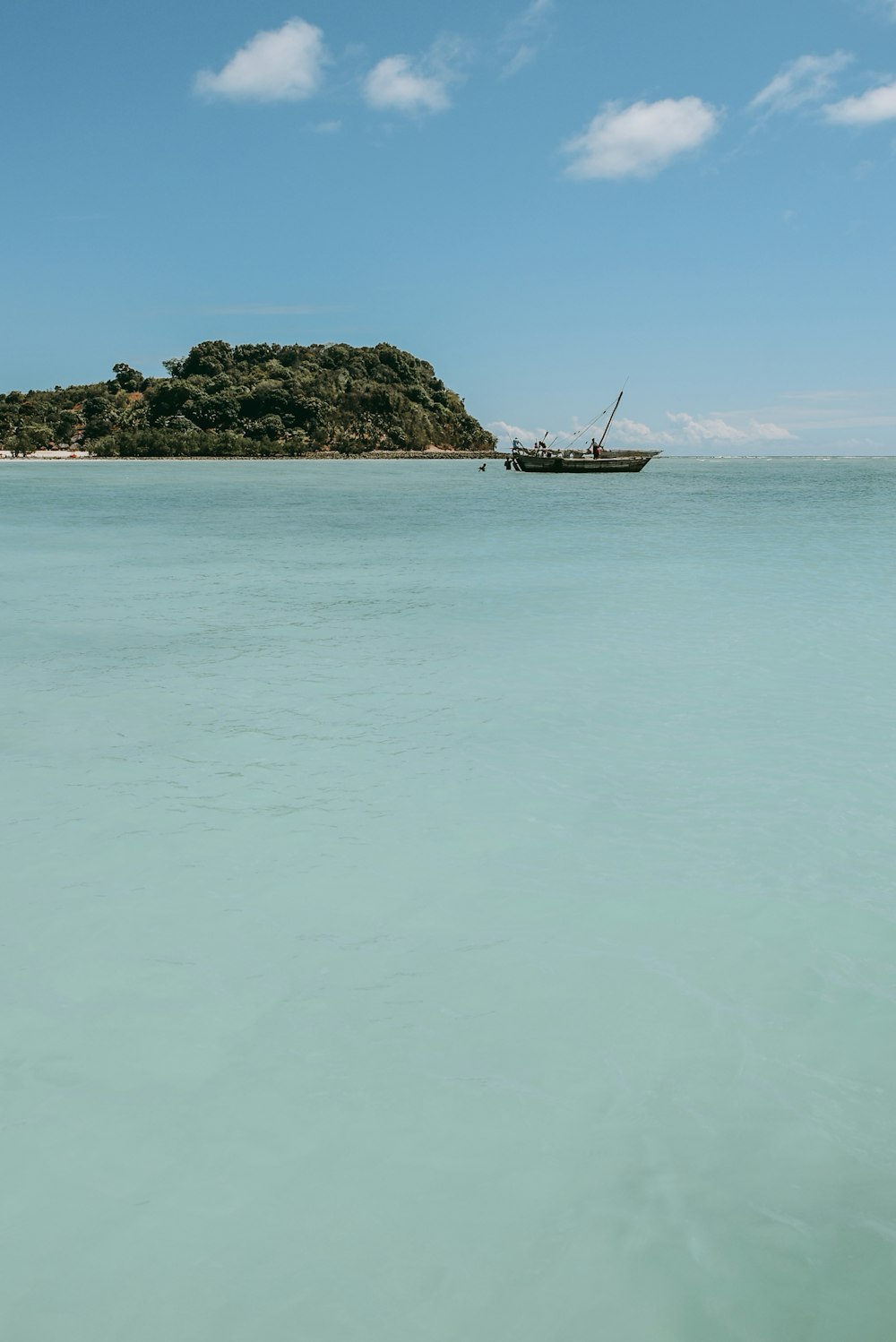 white and brown boat on sea during daytime