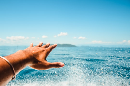 persons left hand with blue manicure in Nosy Be Madagascar