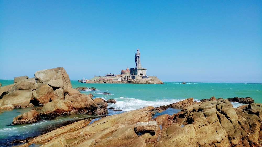 brown rock formation on sea during daytime