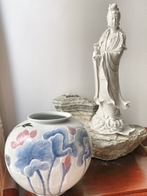 Close-up of a delicate Asian porcelain artwork resting on a polished wooden stand.$8500