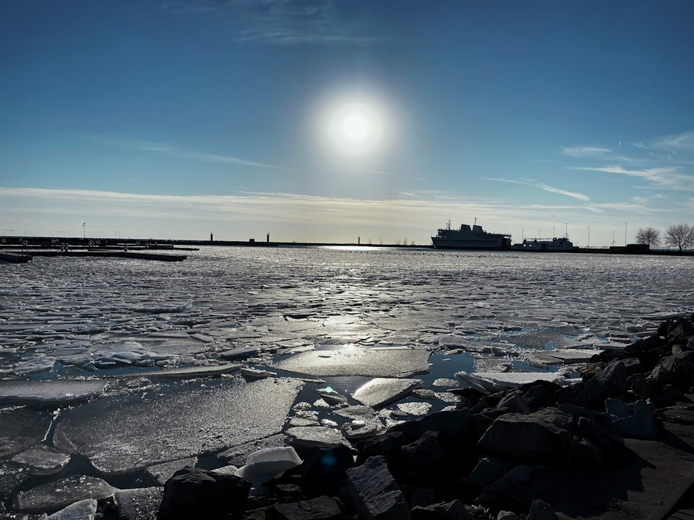 black rocks on sea shore during daytime