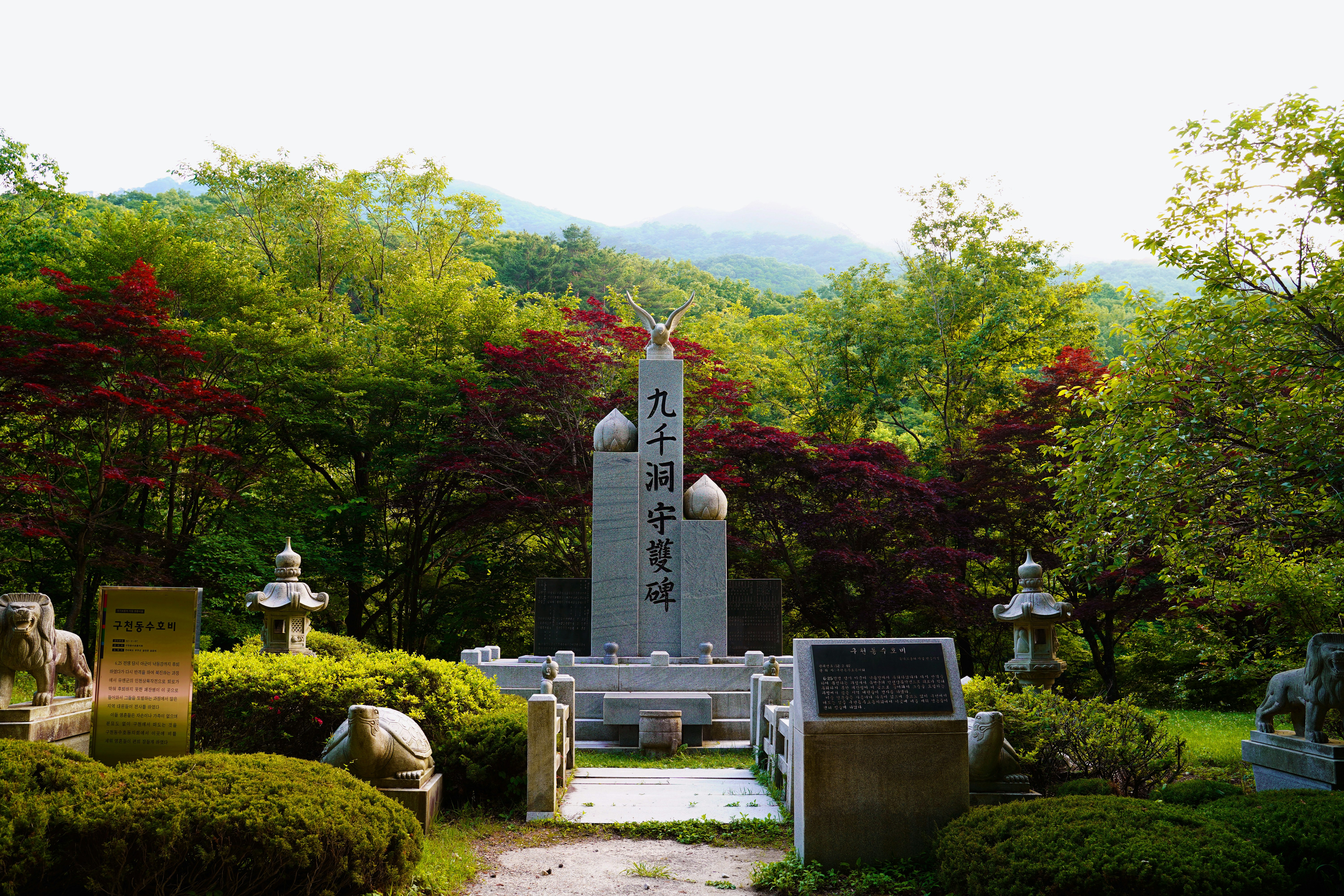 gray concrete tower near green trees during daytime