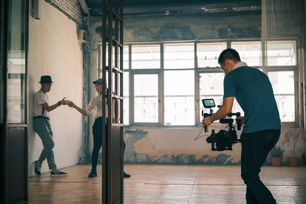 a man standing in front of a mirror holding a camera