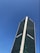 A tall skyscraper with the Samsung logo is prominently featured, set against a clear blue sky. The building is modern with a sleek glass façade.