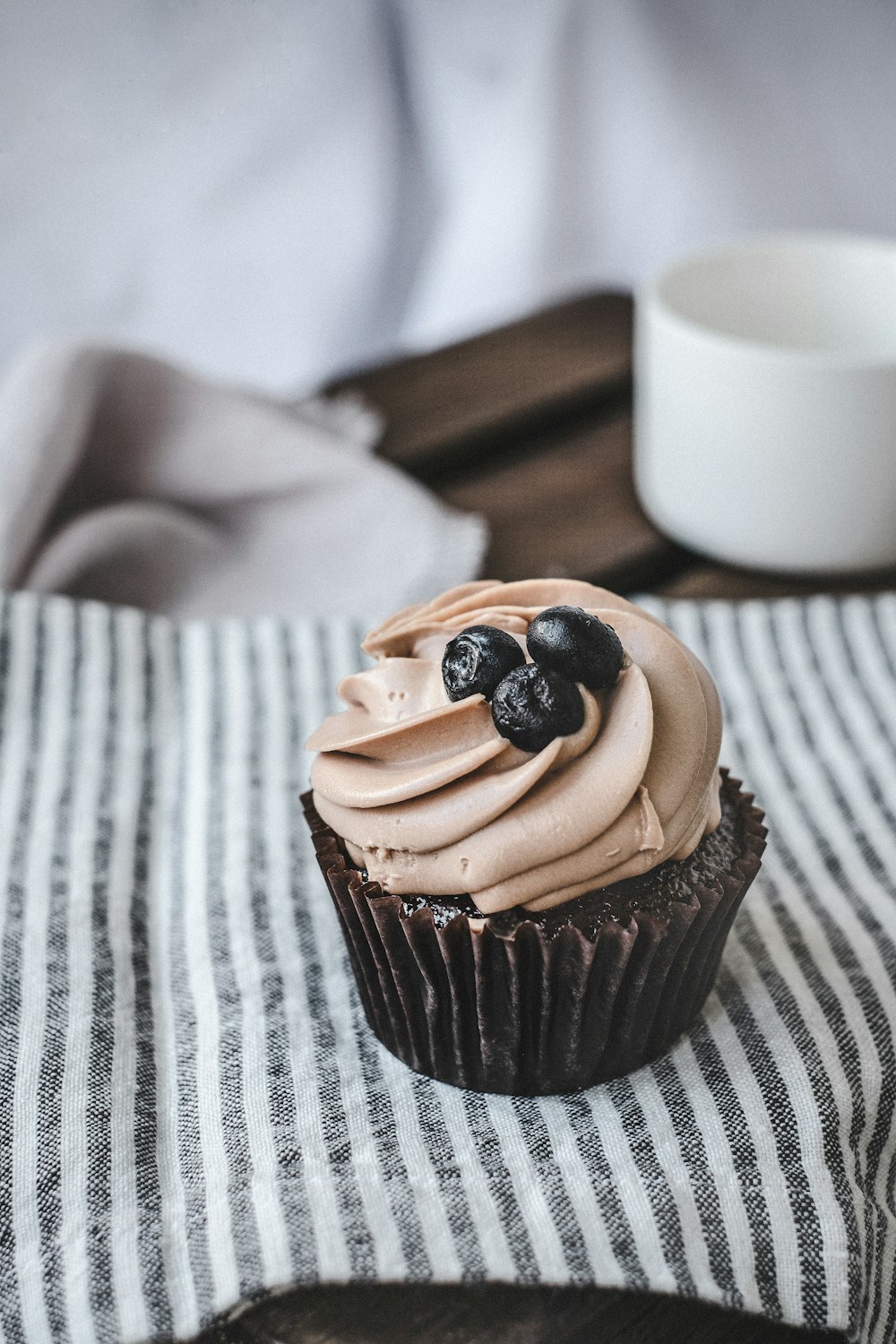chocolate cupcake with chocolate on white textile