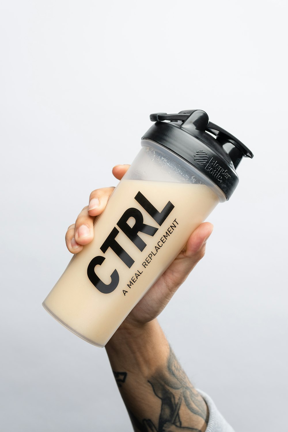 a person holding a coffee cup with the word ctrl on it