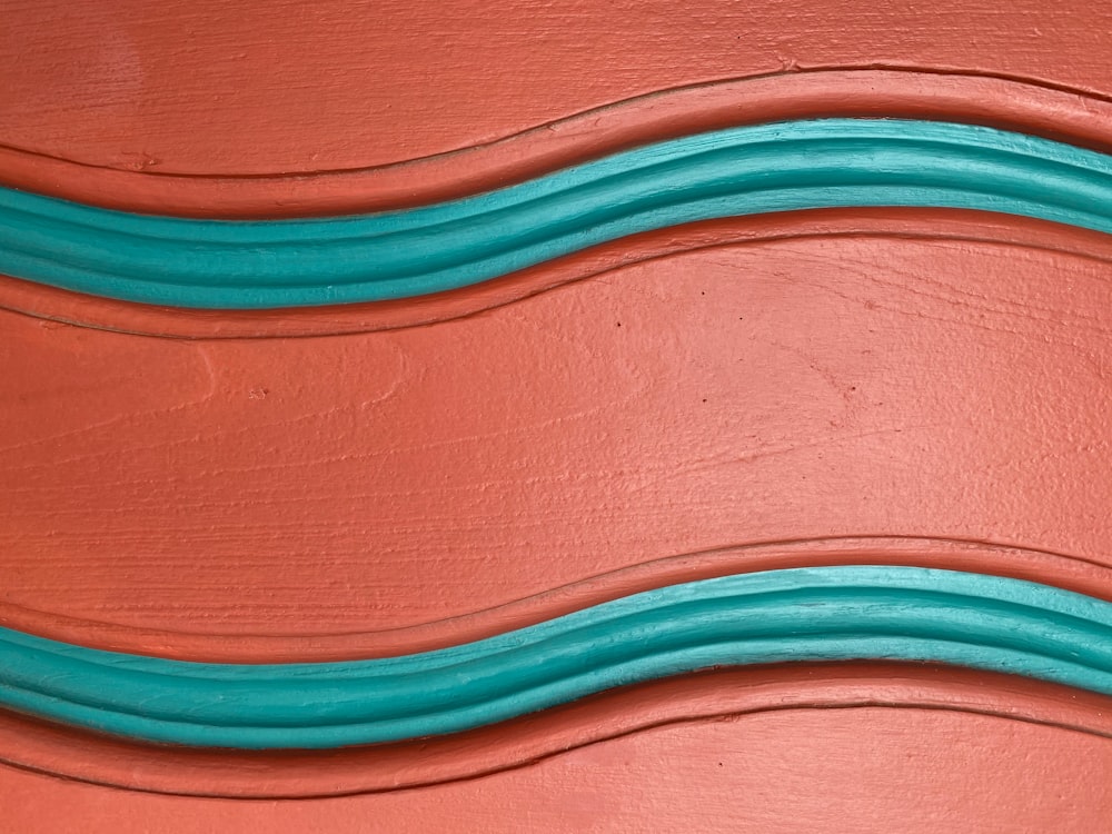 blue coated wire on brown wooden surface
