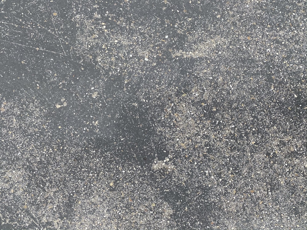 white and black stone on gray concrete floor