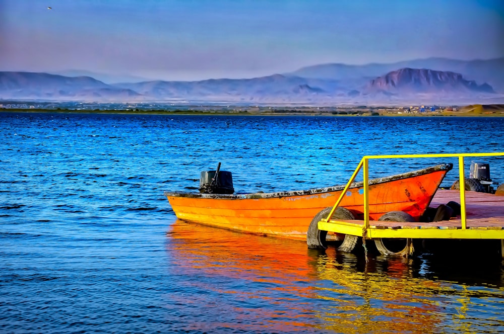 brown and green boat on body of water during daytime