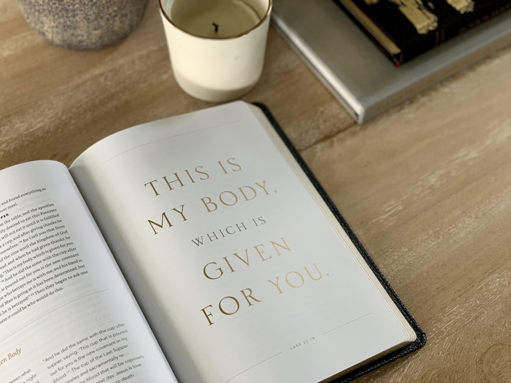 an open book sitting on top of a wooden table