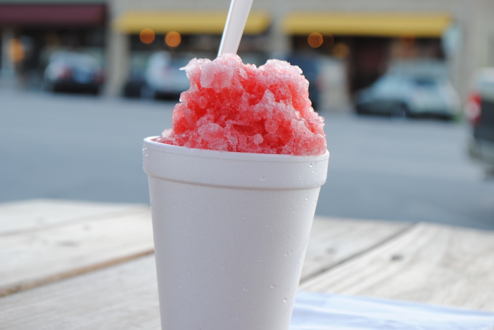 pink ice cream in white cup